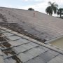 Roof in Florida showing heat and humidity damage with cracked shingles and moisture stains