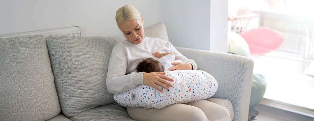 Close-up of memory foam nursing pillow features and removable cover.
