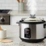 Compact Aroma 2-Cup mini rice cooker on kitchen counter with steaming rice