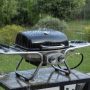 Durable stainless steel gas grill standing strong during rainy outdoor weather
