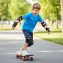 Young child skateboarding while wearing full BOSONER protective gear set including knee, elbow, and wrist pads