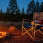 Affordable portable camping chair setup at outdoor campsite with campfire