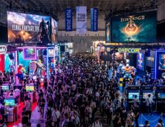 A packed exhibition hall at Tokyo Game Show 2026 at Makuhari Messe in Chiba, Japan, with colorful gaming booths, giant screens displaying game trailers, and thousands of visitors