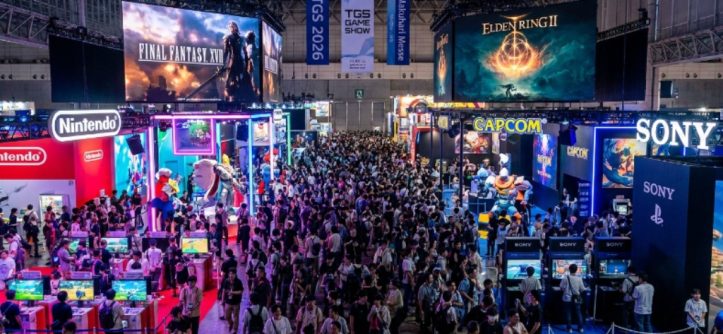 A packed exhibition hall at Tokyo Game Show 2026 at Makuhari Messe in Chiba, Japan, with colorful gaming booths, giant screens displaying game trailers, and thousands of visitors