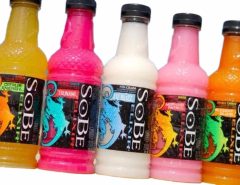 Vintage SoBe drink bottles displayed on a retail shelf with colorful packaging and lizard logo