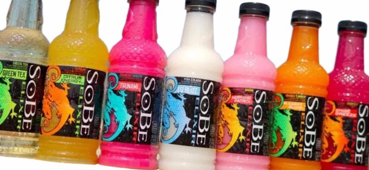 Vintage SoBe drink bottles displayed on a retail shelf with colorful packaging and lizard logo