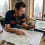 Cyclist planning a cycling route using maps and elevation data
