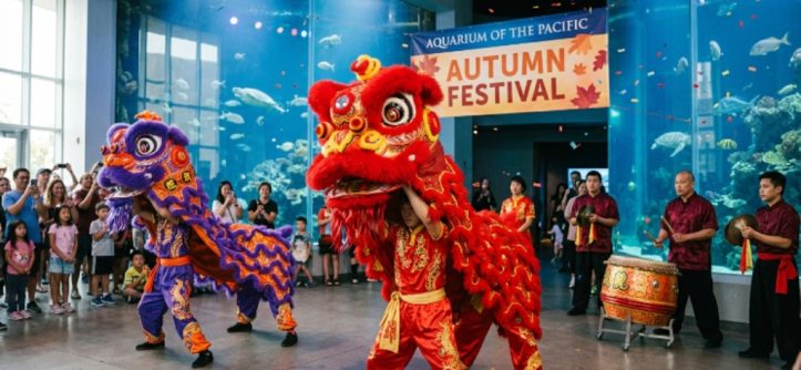 Performers in colorful traditional costumes during a lion dance at the Aquarium of the Pacific Autumn Festival