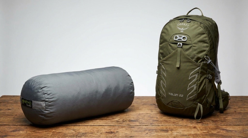 Hiker relaxing inside a tent using a supportive camping neck pillow.